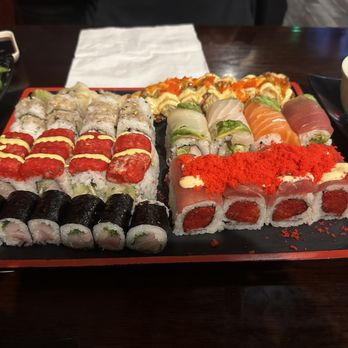 Sushi Mido - Back to front (left to right): baby octopus roll, sunrise roll, yellowtail scallion, Batman roll, rainbow roll, and Ahi Tuni roll - Japanese Near Me - Shawnee, Kansas