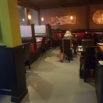 Zeitoon Restaurant - a woman sitting at a table - Persian/Iranian Near Me - Port Moody, British Columbia Zeitoon Restaurant - a woman sitting at a table - Persian/Iranian Near Me - Port Moody, British Columbia
