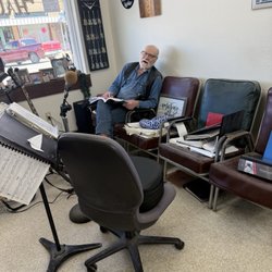 Florence Hair Emporium - Warren Earp strumming his guitar between haircuts. He is a hidden treasure.