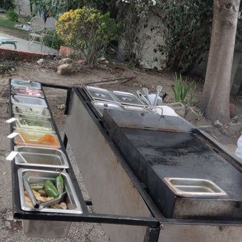 Lorenas Bomb Tacos - a line of food being prepared - Street Vendors Near Me