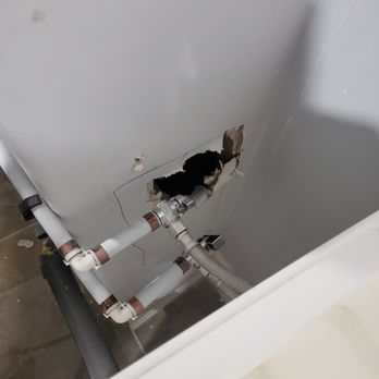 Jstar Construction - a hole in the wall of a bathtub - General Contractors Near Me
