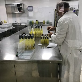 I Giardini di Cataldo - An employee bottling their own limoncello - Organic Stores Near Me - Sorrento, NA I Giardini di Cataldo - An employee bottling their own limoncello - Organic Stores Near Me - Sorrento, NA
