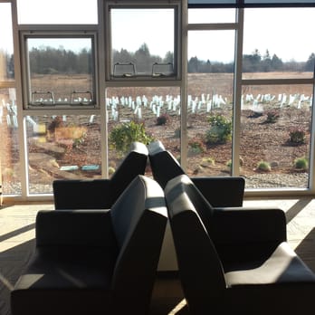 Ferndale Public Library - There are lounge chairs next to large picture windows that let in lots of light & provide a view of the wetlands. - Libraries Near Me - Ferndale, Washington