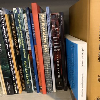 Totem Books - a bookshelf full of books - Bookstores Near Me - Flint, Michigan