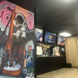 El Toque - Painted murals and the counter where you can order to go
