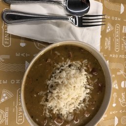 a bowl of beans and rice on a tray a bowl of beans and rice on a tray