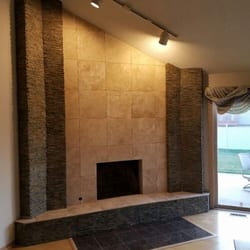 PowerHouse Remodeling & Repair - Fireplace Facelift.  This fireplace was an old brick fireplace thatbwas updated with Travertine and Stack Stone