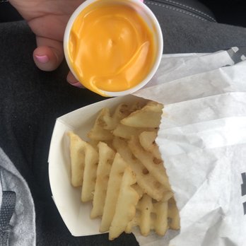 Mr Hero - a person holding a cup of mustard and fries - Sandwiches Near Me - Columbus, Ohio