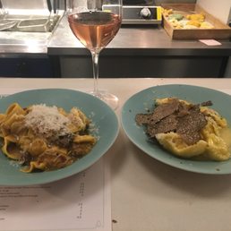 Pappardelle with rabbit ragú and olives on the left; agnolotti (like tortellini) with black truffle and ricotta on the right