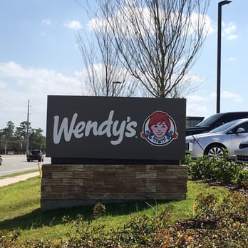 Wendy's - a sign for wendy's with cars in the background - Fast Food Near Me - Orlando, Florida Wendy's - a sign for wendy's with cars in the background - Fast Food Near Me - Orlando, Florida