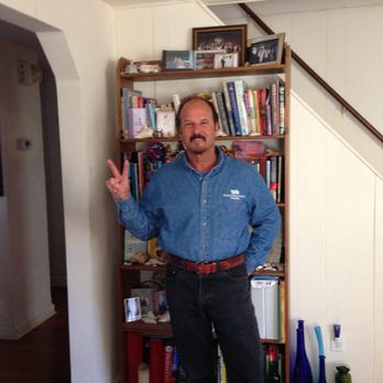 TJB Plumbing Heating - a man standing in front of a bookcase - Plumbing Near Me TJB Plumbing Heating - a man standing in front of a bookcase - Plumbing Near Me