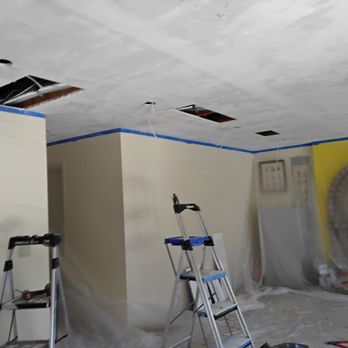 Zest 4 construction - MIDWAY - Family room. Ali cut the holes to run new wiring for the recessed lights - General Contractors Near Me