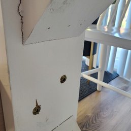 Unfinished rough wood and cracked from hardware installation