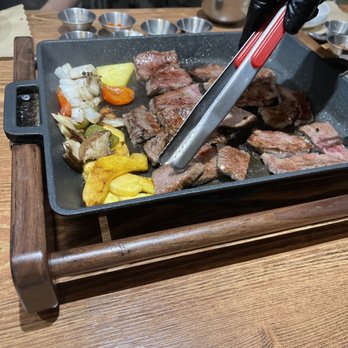 Prime No 7 - Everything is grilled on this iron pan via induction. - Korean Near Me - Mahwah, New Jersey