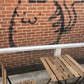 Potomac Chocolate - Graffiti Cat graffitied on brick wall outside - Chocolatiers & Shops Near Me - Occoquan, Virginia