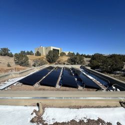 Positive Energy Solar - Solar panels installed on a flat roof in Santa Fe, New Mexico