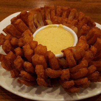 Outback Steakhouse - The signature Bloomin' Onion ($10) is battered, deep fried, served w/horseradish sauce. This is nearly 2,000 calories! - Steakhouses Near Me - Merrillville, Indiana Outback Steakhouse - The signature Bloomin' Onion ($10) is battered, deep fried, served w/horseradish sauce. This is nearly 2,000 calories! - Steakhouses Near Me - Merrillville, Indiana
