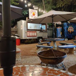 a food truck and tables a food truck and tables