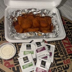 This -N- That Eatery - Buffalo boneless wings with a side of ranch. Some parmesan and red pepper seasonings to go.