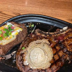 Frontier Steakhouse - Ribeye steak bone in and a Loaded Baked Potato