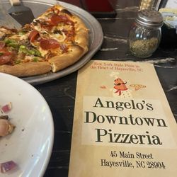 Deluxe pizza with no peppers or olives on half and the menu
