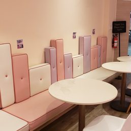 a row of pink and white tables and chairs a row of pink and white tables and chairs