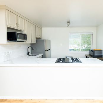 Crossbeam Builders - Bright Salt Lake condo kitchen refresh featuring sleek quartz counters, modern fixtures, and smart design for small-space living. - General Contractors Near Me - Salt Lake City, Utah Crossbeam Builders - Bright Salt Lake condo kitchen refresh featuring sleek quartz counters, modern fixtures, and smart design for small-space living. - General Contractors Near Me - Salt Lake City, Utah