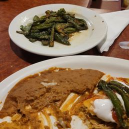 Enchilada trio and a side of grilled jalapenos Enchilada trio and a side of grilled jalapenos