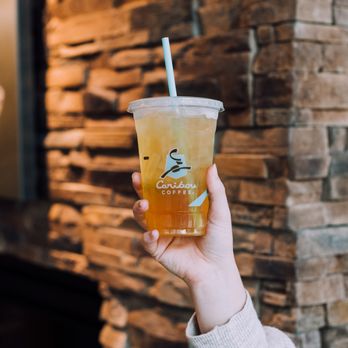 Caribou Coffee - a person holding a cup of coffee - Coffee & Tea Near Me - Richfield, Minnesota Caribou Coffee - a person holding a cup of coffee - Coffee & Tea Near Me - Richfield, Minnesota