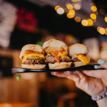 Bronx Alehouse - a person holding a plate of sliders - American Near Me - Bronx, New York Bronx Alehouse - a person holding a plate of sliders - American Near Me - Bronx, New York
