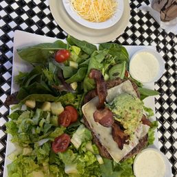 Guacamole bacon burger NO bun, on the house salad bed. Guacamole bacon burger NO bun, on the house salad bed.
