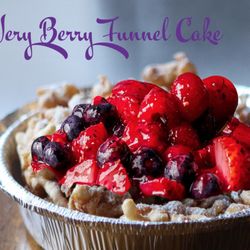 Fairgroundz - Fresh seasonal mixed berry funnel cake lightly dusted with powdered sugar and strawberry syrup drizzle.