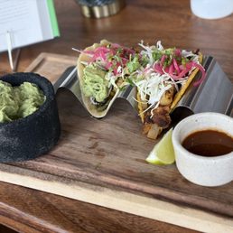 Tacos (grilled veggies & vegan al pastor) plus a side of guac. Tacos (grilled veggies & vegan al pastor) plus a side of guac.