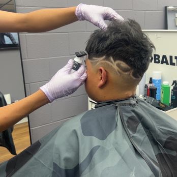 Venus Barbershop - This is a kids haircut a low fade messy look on top,with a design on the side. - Barbers Near Me - Venus, Texas Venus Barbershop - This is a kids haircut a low fade messy look on top,with a design on the side. - Barbers Near Me - Venus, Texas