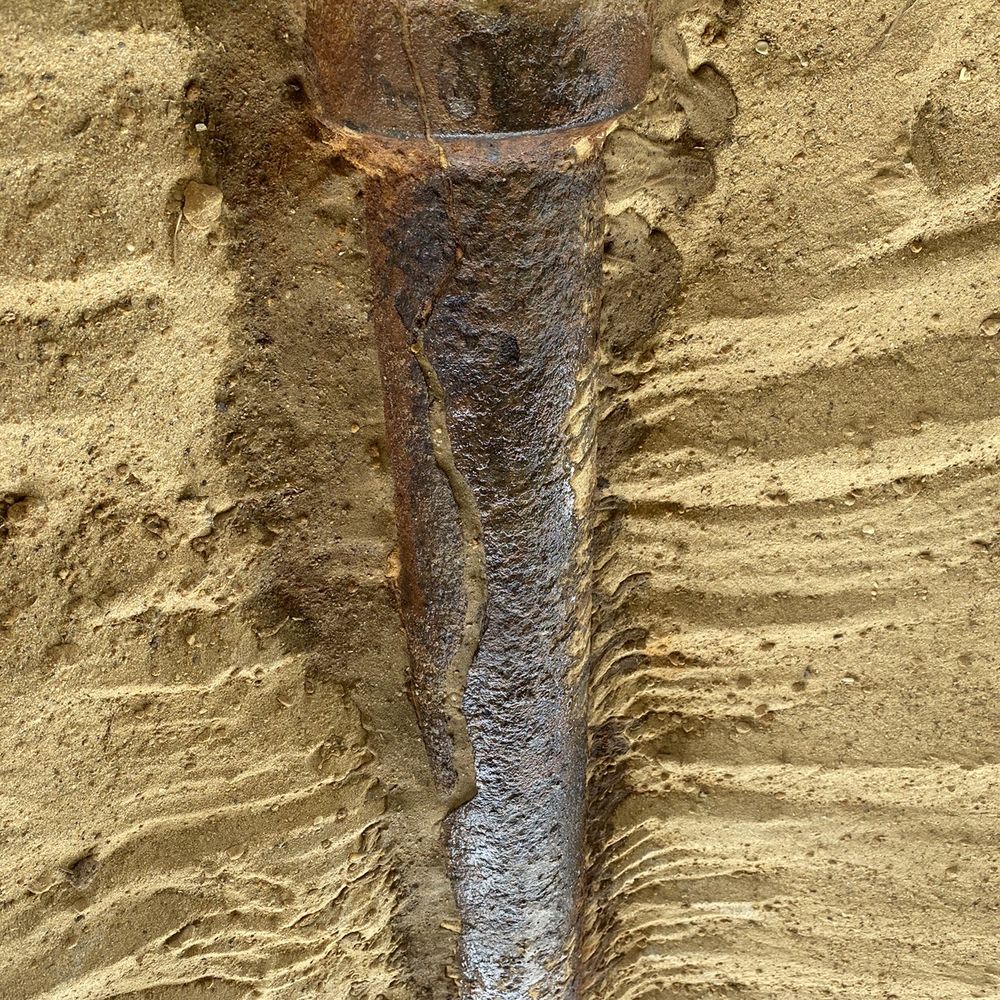 McClure Realty Vacations - Old sewage pipe in the sand under the house - Property Management Near Me - Ocean Isle Beach, North Carolina