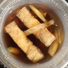Udon broth with green onions, carrots, onions, and fish cake