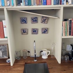 Customcut Interiors - shelf has fallen down and lighting now shows without a shade to buffer it. Same problem on the opposite wall