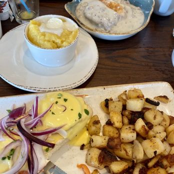 First Watch - Smoked salmon eggs Benedict with breakfast potatoes (nearest), buttered grits, biscuit and gravy - Breakfast & Brunch Near Me - Willis, Texas