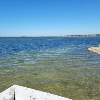 Sailport Waterfront Suites - View across Tampa Bay of Ben T Davis Beach, from the end of the fishing pier - Hotels Near Me - Tampa, Florida Sailport Waterfront Suites - View across Tampa Bay of Ben T Davis Beach, from the end of the fishing pier - Hotels Near Me - Tampa, Florida