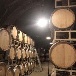 Bella Vineyards & Wine Caves - Stacked barrels in the cave at Bella