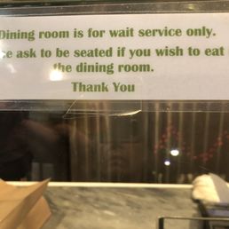 a sign that reads dining room is for wait service only please ask to be seated if you wish to eat the