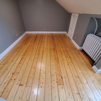 Millennium Flooring - a hardwood floor with a radiator - Refinishing Services Near Me - Hyannis, Massachusetts