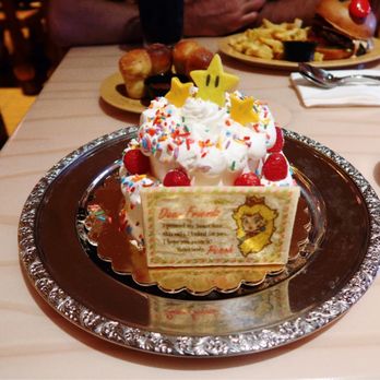 Toadstool Cafe - Princess Peach's Cake Yellow cake whipped topping, with raspberries, apple, sprinkles, star chocolates, star cookie, Princess Peach cookie. - Burgers Near Me - Orlando, Florida Toadstool Cafe - Princess Peach's Cake Yellow cake whipped topping, with raspberries, apple, sprinkles, star chocolates, star cookie, Princess Peach cookie. - Burgers Near Me - Orlando, Florida