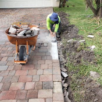 Tree Service Experts - a man with a wheelbarrow - Landscaping Near Me