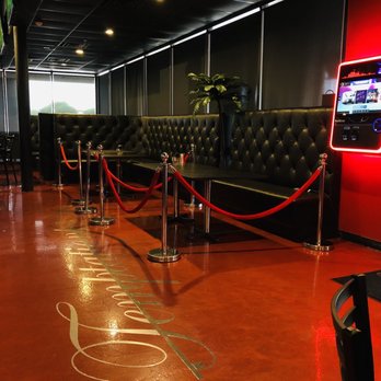 Temptations - a red neon sign on the floor of a restaurant - Lounges Near Me - Arlington, Texas