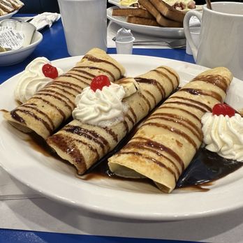 Restaurant Patachou - Crepes with banana inside and Nestle chocolate syrup, with (real) whipped cream and maraschino cherries. Good coffee in the background. - Breakfast & Brunch Near Me - Trois-Rivieres, Quebec Restaurant Patachou - Crepes with banana inside and Nestle chocolate syrup, with (real) whipped cream and maraschino cherries. Good coffee in the background. - Breakfast & Brunch Near Me - Trois-Rivieres, Quebec
