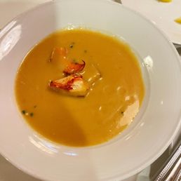Lobster bisque soup with seafood garnish