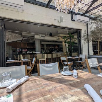 Delbar Middle Eastern - Outside on the covered patio, looking in towards the bar. They had an uncovered patio outside the storefront too. - Persian/Iranian Near Me - Atlanta, Georgia