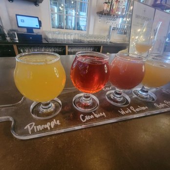 Resurgence Brewing Co - Mimosa Flight - 2 champagne Mimosas on the left (pineapple and cranberry) and 2 beer-mosas on the right. - Breweries Near Me - Buffalo, New York
