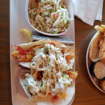 Funky Pelican - Lobsret tacos and Fish Sandwiche are pictured with a broccoli slaw. - Seafood Near Me - Flagler Beach, Florida Funky Pelican - Lobsret tacos and Fish Sandwiche are pictured with a broccoli slaw. - Seafood Near Me - Flagler Beach, Florida